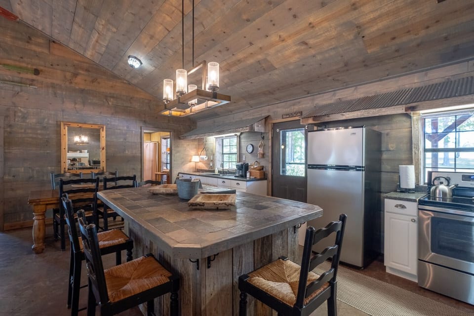 The large kitchen island is the center of activity.  