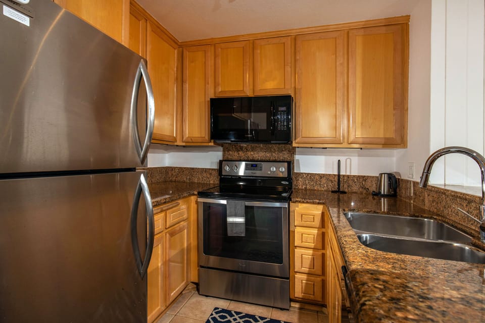 The kitchen features granite countertops and stainless appliances.