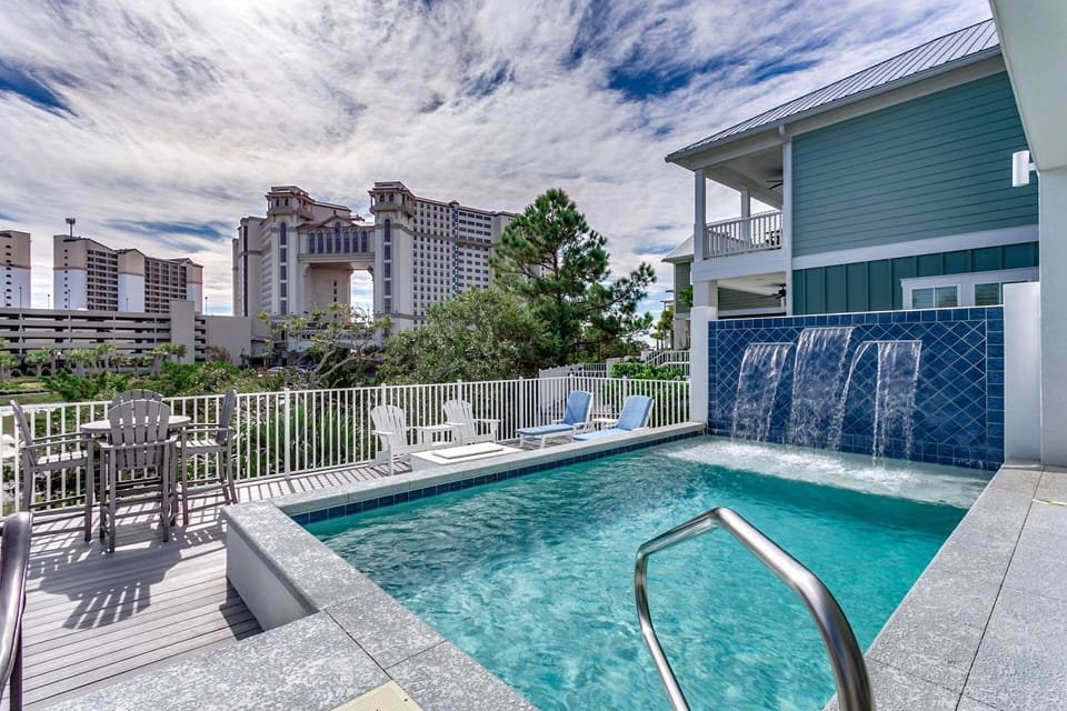 Beautiful private pool with waterfall — all set against the backdrop of the oceanfront towers.