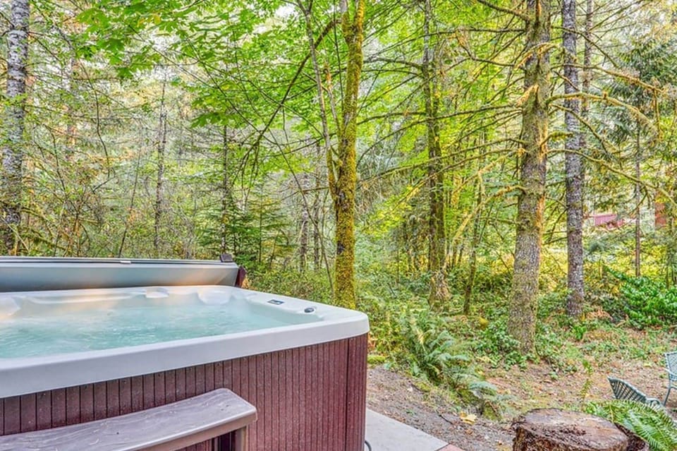 Hot tub opens to large back yard that backs up to acres of private woods.