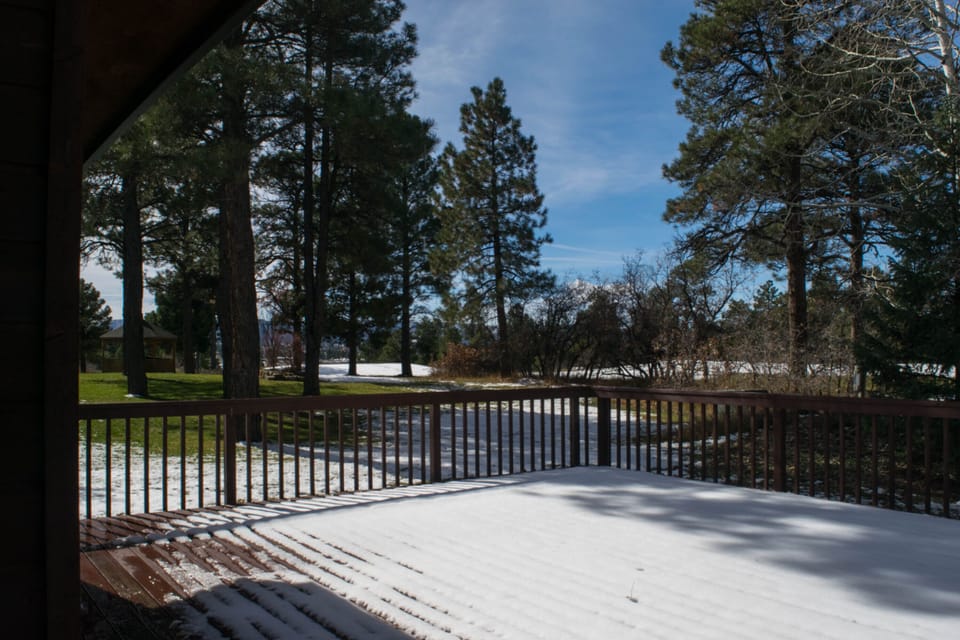 Beautiful view from deck surrounded by native trees, golf course and mountains!