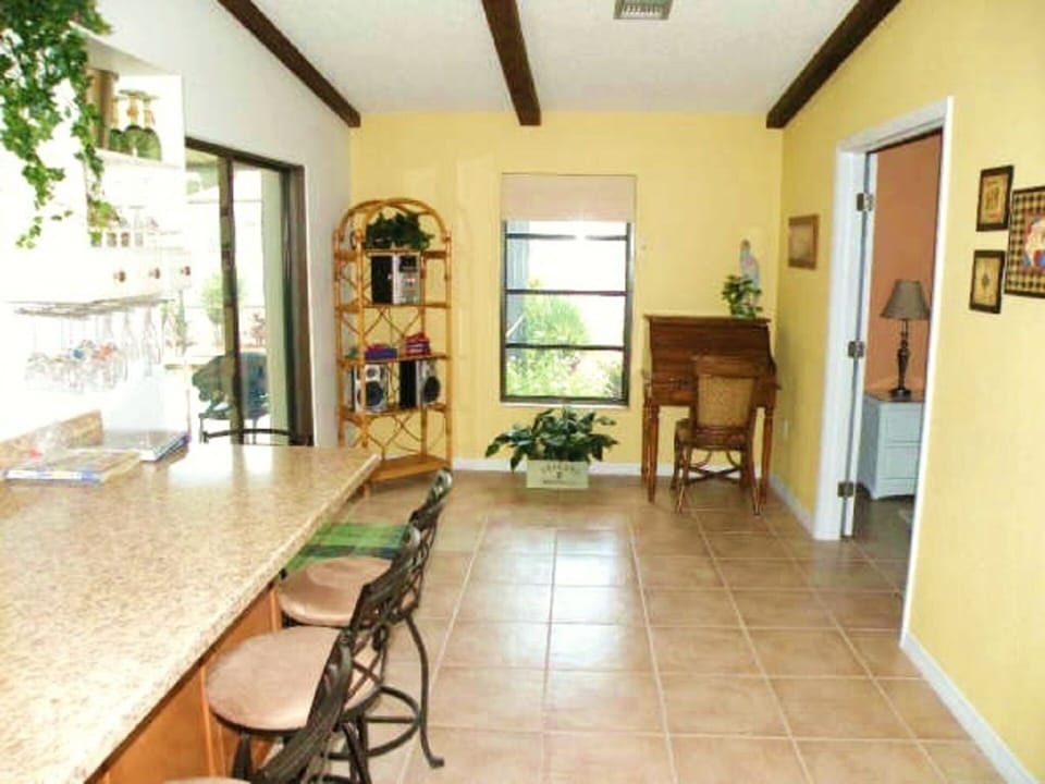 Multiple sliding doors from the house to the outdoor pool and entertainment area