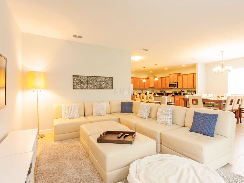 Relax in the cozy living room with a large sofa and warm lighting.