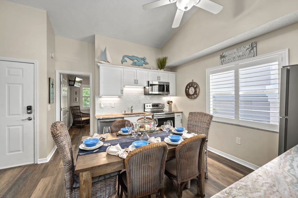 Another angle, another mood—morning light spills across the table while the kitchen quietly waits behind it, ready for your next shared meal or glass of wine.