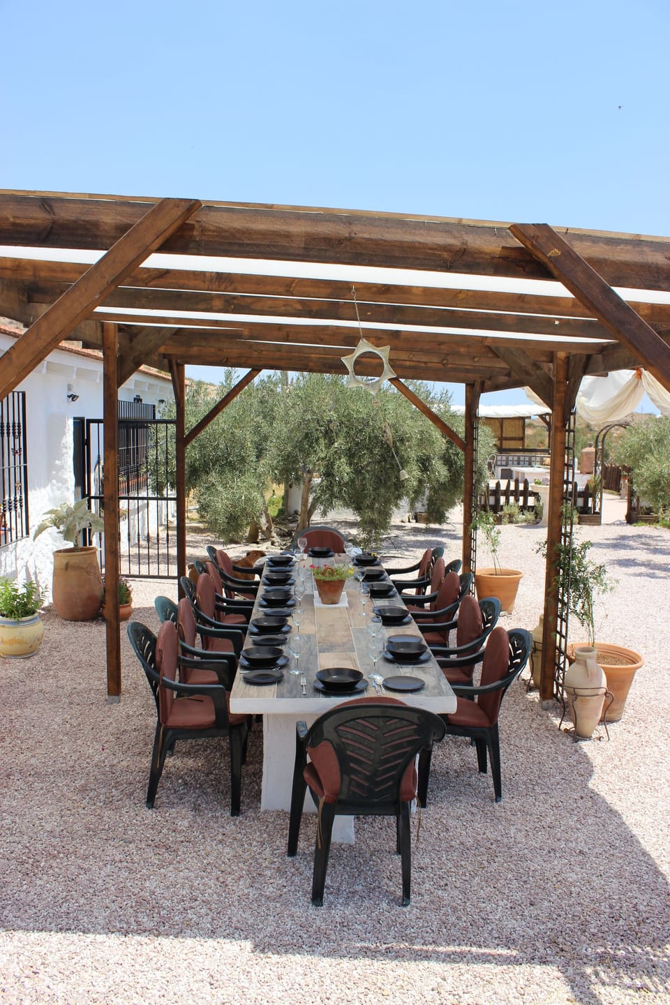 Outside Las Casas Cuevas a dining table seating up to plus 12 people