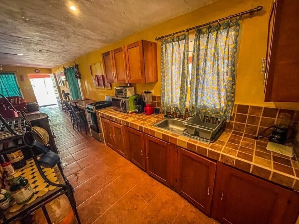 Fully equipped kitchen features propane stove/oven, microwave, blender and more.
