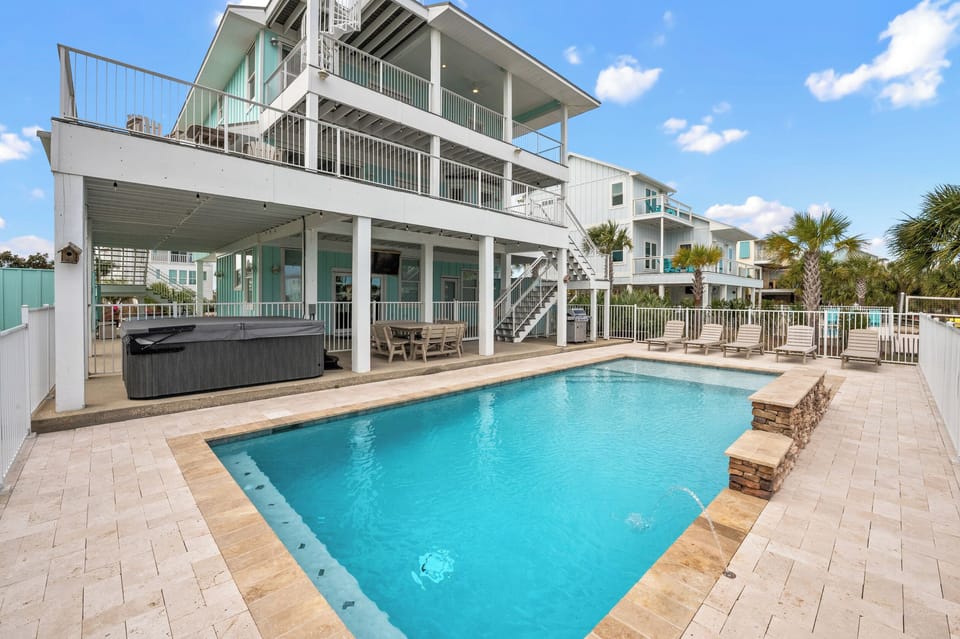 Relax by the pool with a soothing waterfall and jets