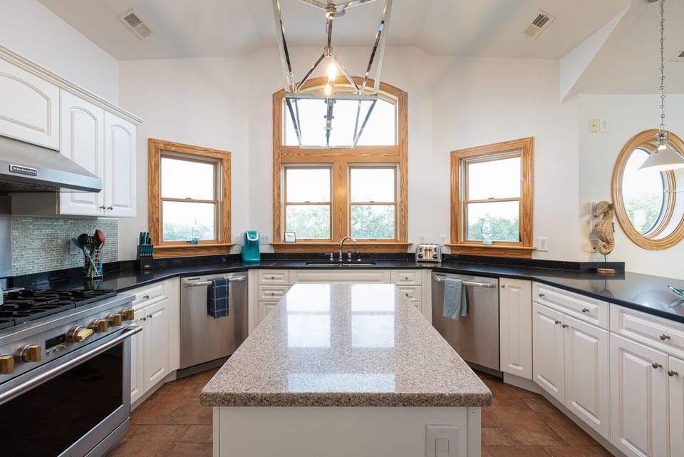 Large gas stove and island work area.