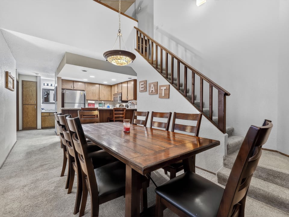 Gather your group around this spacious dining table for memorable meals, with a fully equipped kitchen ready for your culinary adventures.