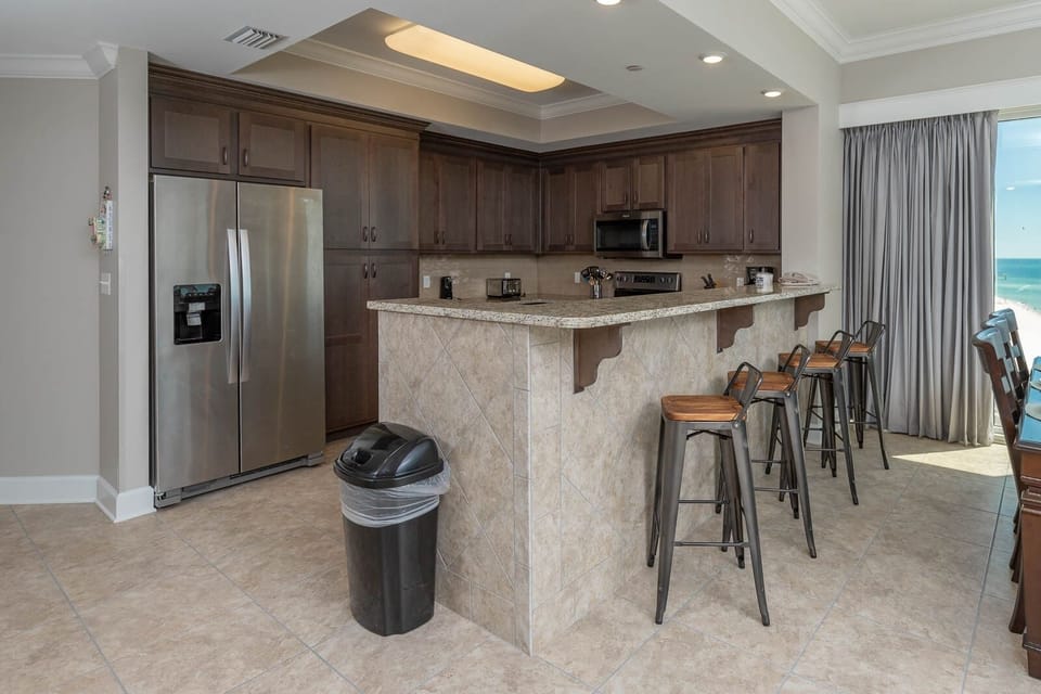 Wake up with morning coffee at the breakfast bar and get ready for a beach day in this stylish space