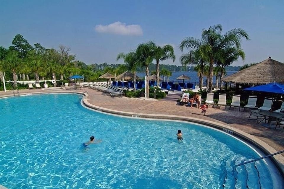 Heated pool with beach and lake beyond (2 mins from our condo)