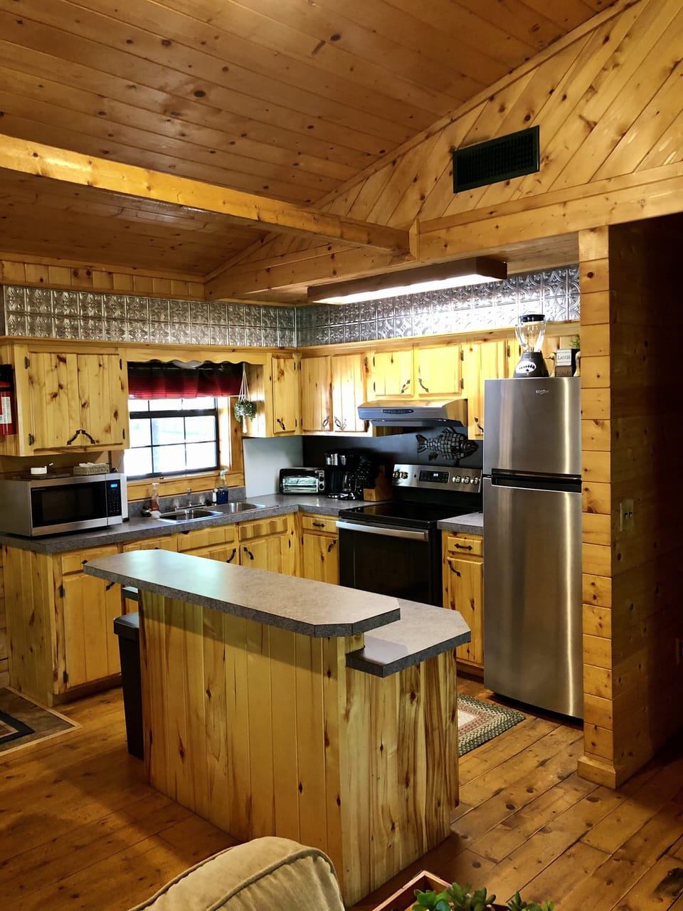 Kitchen with stove/oven, refrigerator and microwave.