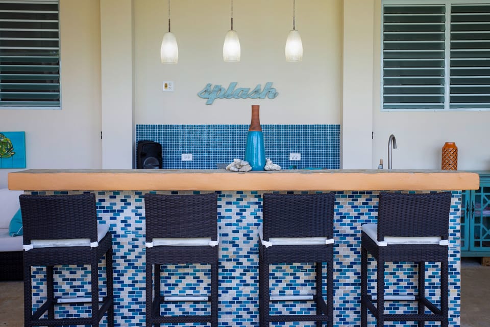 Outdoor patio with sink, mini fridge, and bluetooth speaker