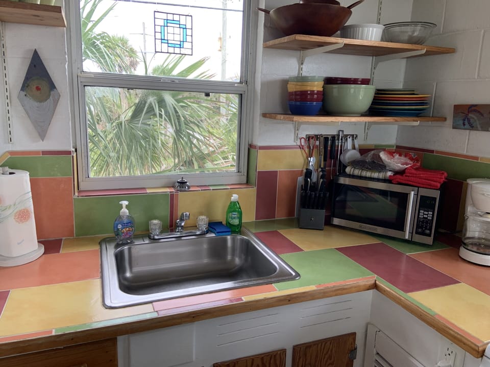 Kitchen equipped with refrigerator, stove/oven, microwave, and others. 