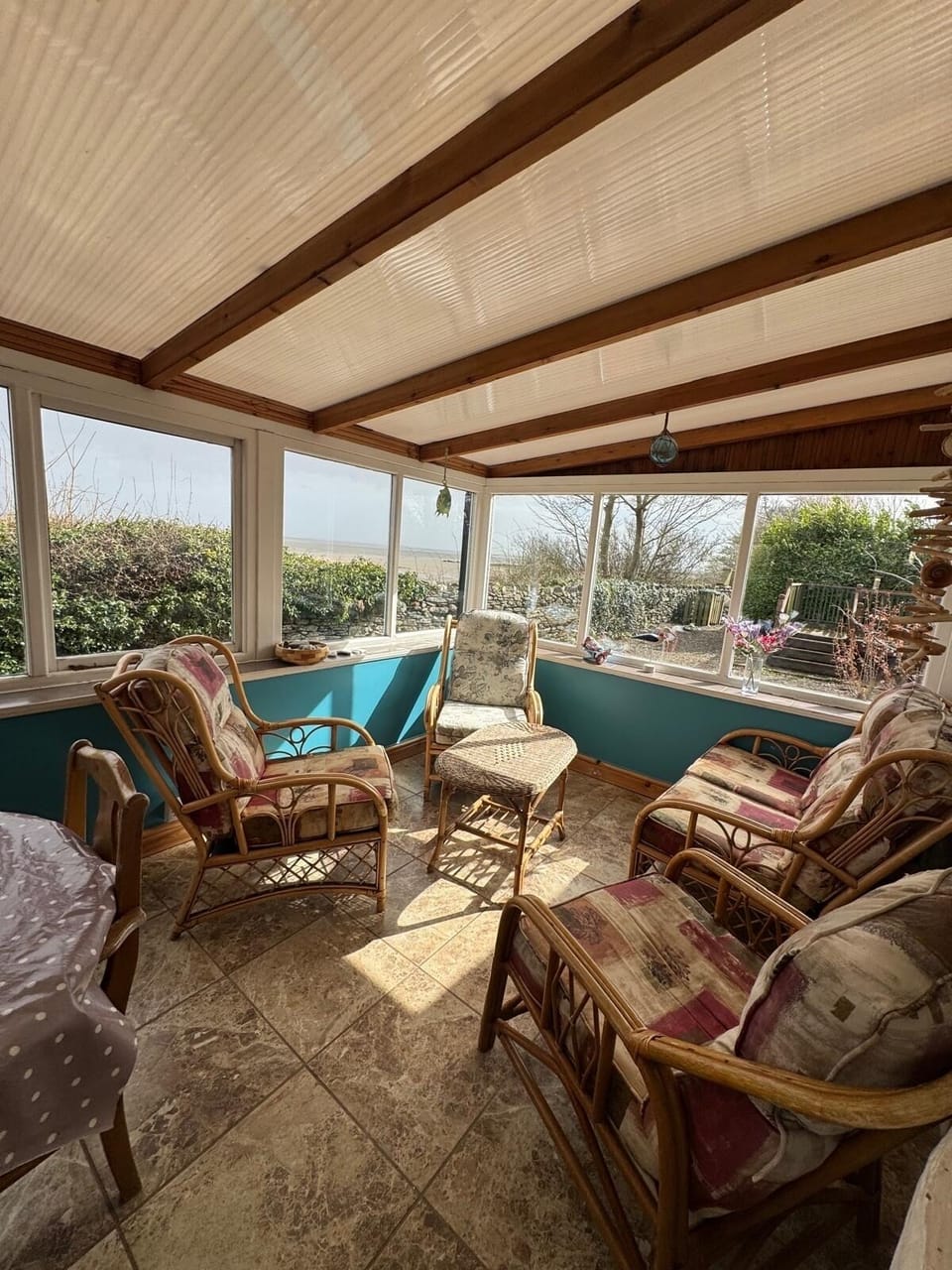 relaxing area of the conservatory with views out over the bay