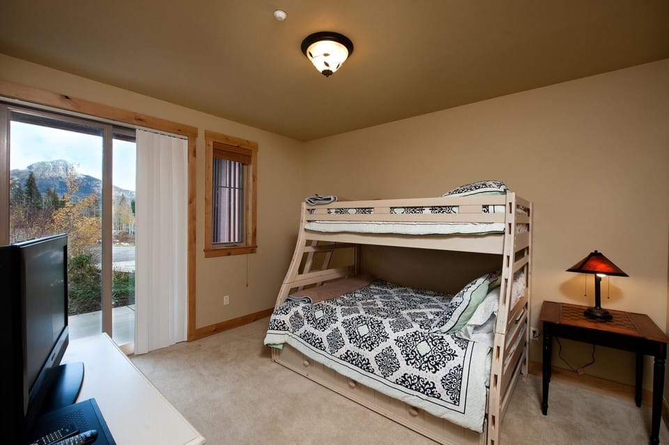 Bedroom with Bunk Bed (Single over Double) and Single Trundle Bed and TV