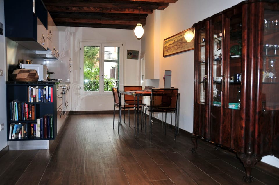 Living-room with furniture, kitchen and window on the garden