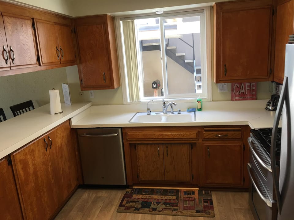 Kitchen fully equipped with stainless steel appliances. 