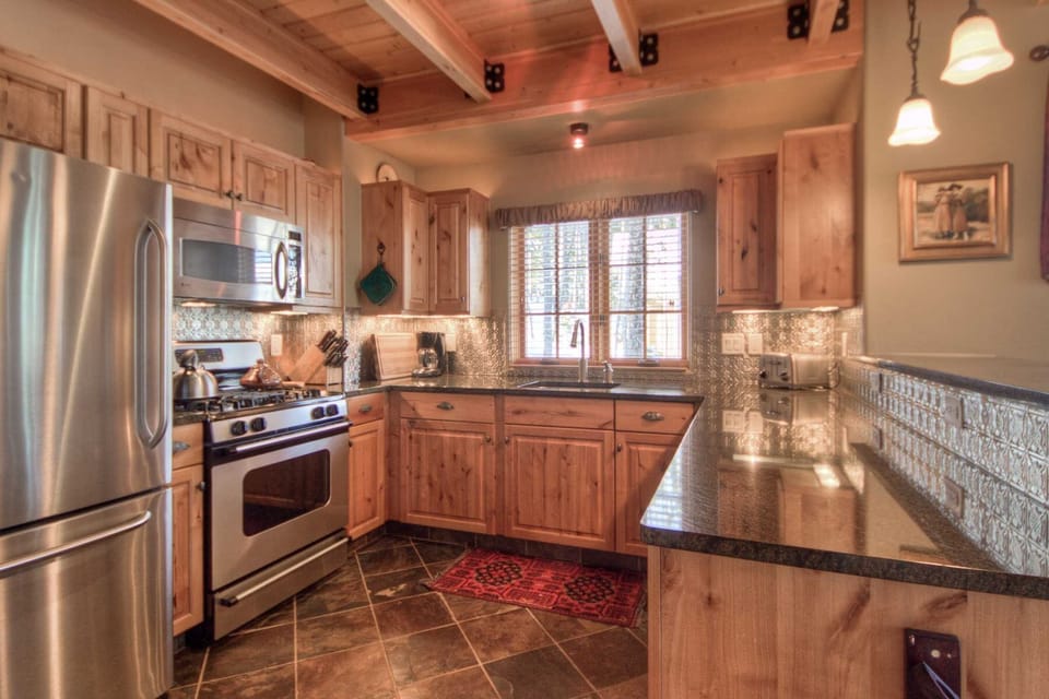 Kitchen opens to dining, living, views