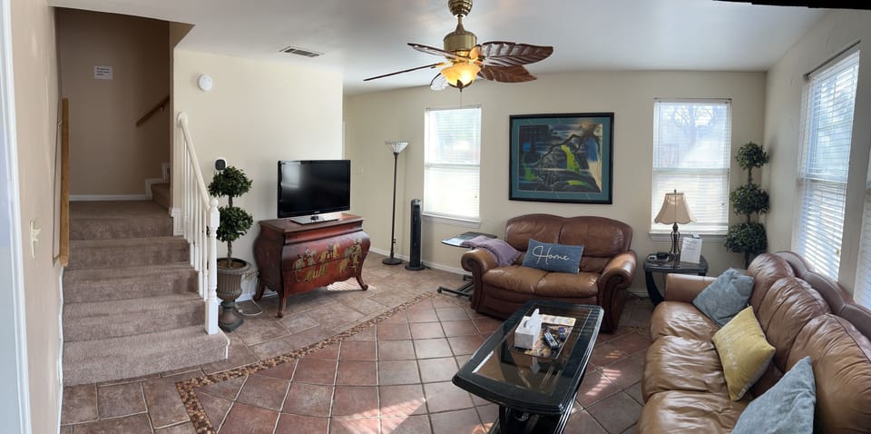 Living area with stairs to upstairs bedrooms and bath.