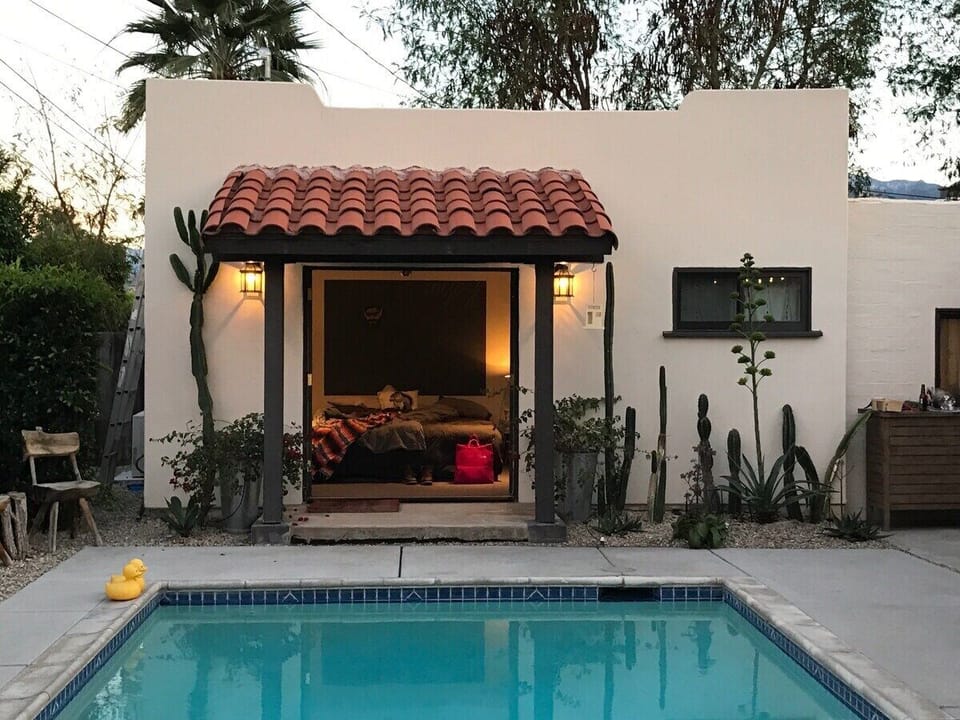 View to detached master bedroom from pool.