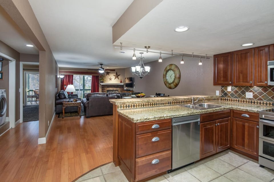 View from entryway of Kitchen, Dining, Living, and Master suite down hall.