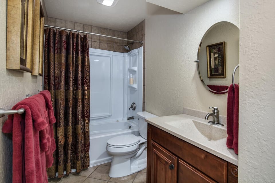 Second bath with shower/tub, toilet, and sink with extended vanity