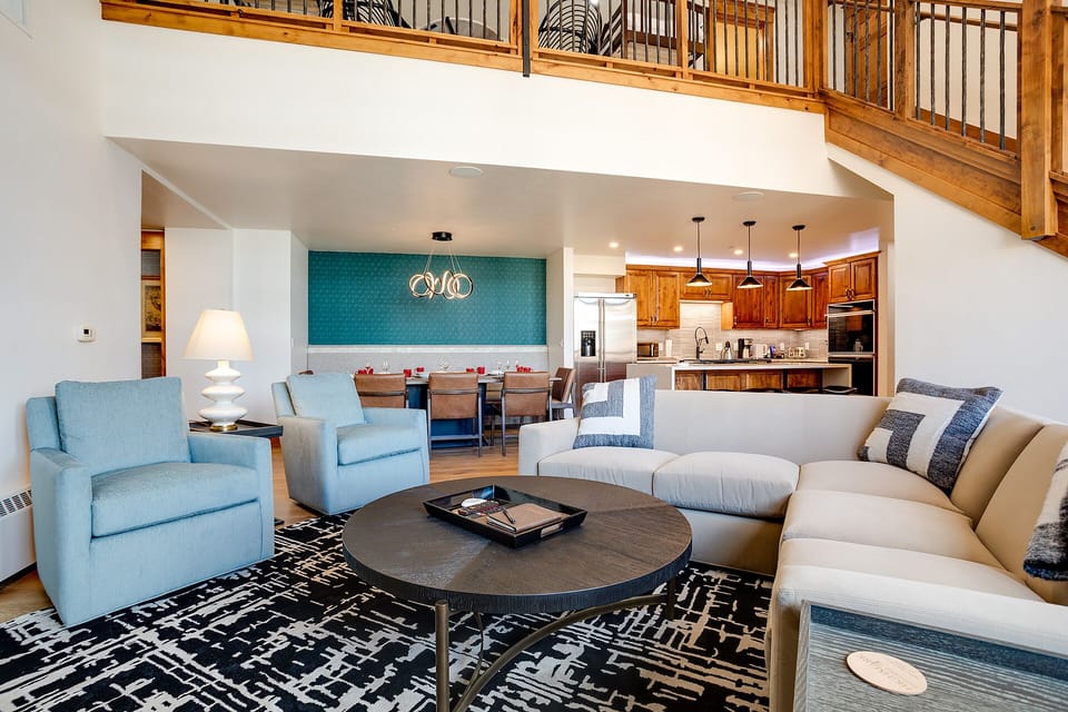 Relax in your spacious open-plan living area with soaring ceilings, plush seating, and a fully equipped kitchen perfect for memorable gatherings.
