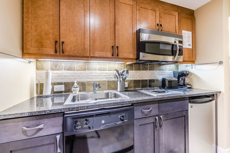 Kitchen - Also offers coffee maker, toaster, and cooking utensils.