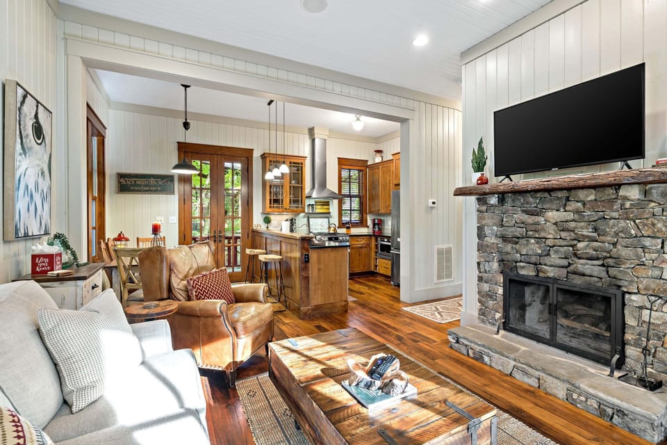 Main-level living room with a wood-burning fireplace and flat-screen TV with streaming options.