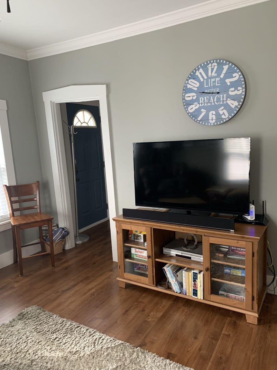 Large Roku TV in living room with streaming channels.