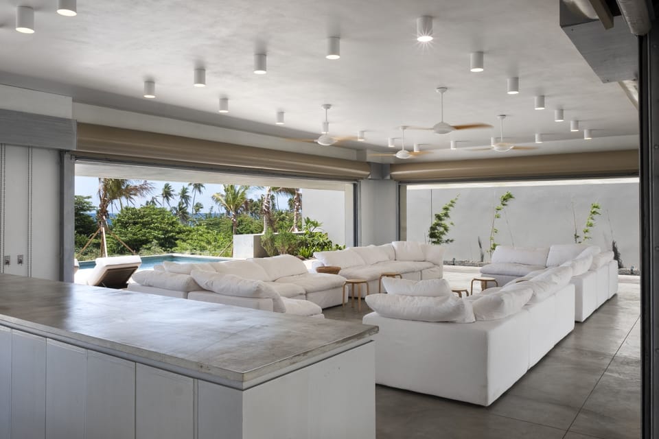 Living room with Caribbean Sea views surrounded by bamboo gardens.
