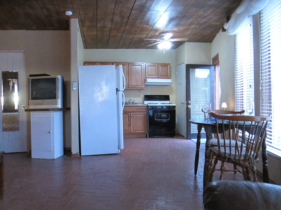 Brick floors throughout.  Full size refrigerator with gas range. 
