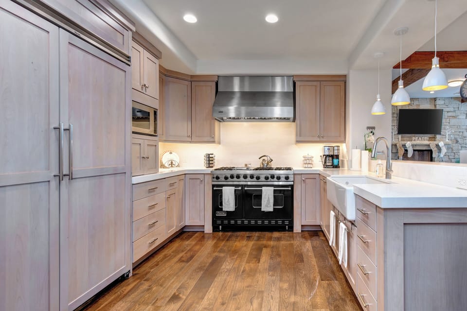 Gourmet Kitchen with Viking Appliances, including a 6-Burner Gas Range with Double Ovens, Stone Counters and a Farm Sink