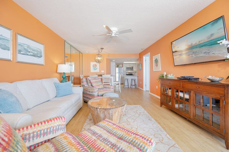The living room wraps you in cozy color and texture while you unwind with favorite shows after fun beach days