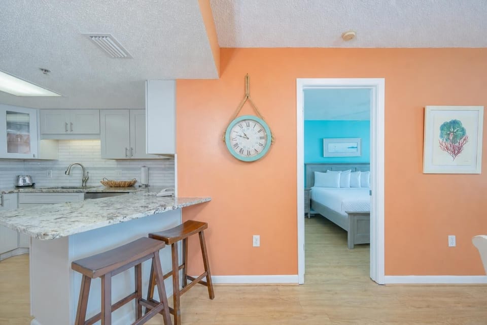 Soft hardwood floors welcome you into the master suite, perfect for restful nights after beach days