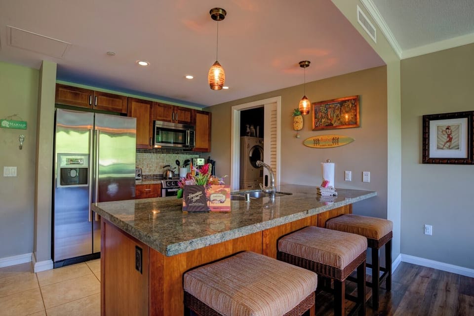 Chic island kitchen with granite countertops and cozy breakfast bar.