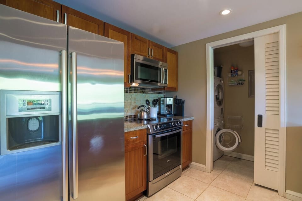 Fully equipped kitchen with sleek appliances and in-unit laundry convenience.