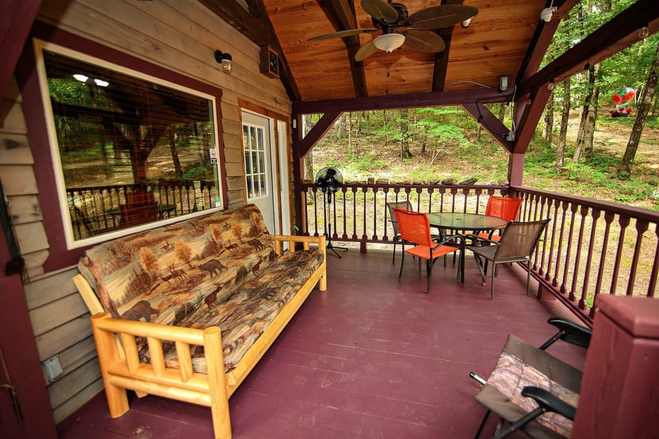 - Spacious covered porch with forest views and seating   - Relaxing outdoor area ideal for morning coffee time   - Peaceful cabin porch designed for nature enjoyment