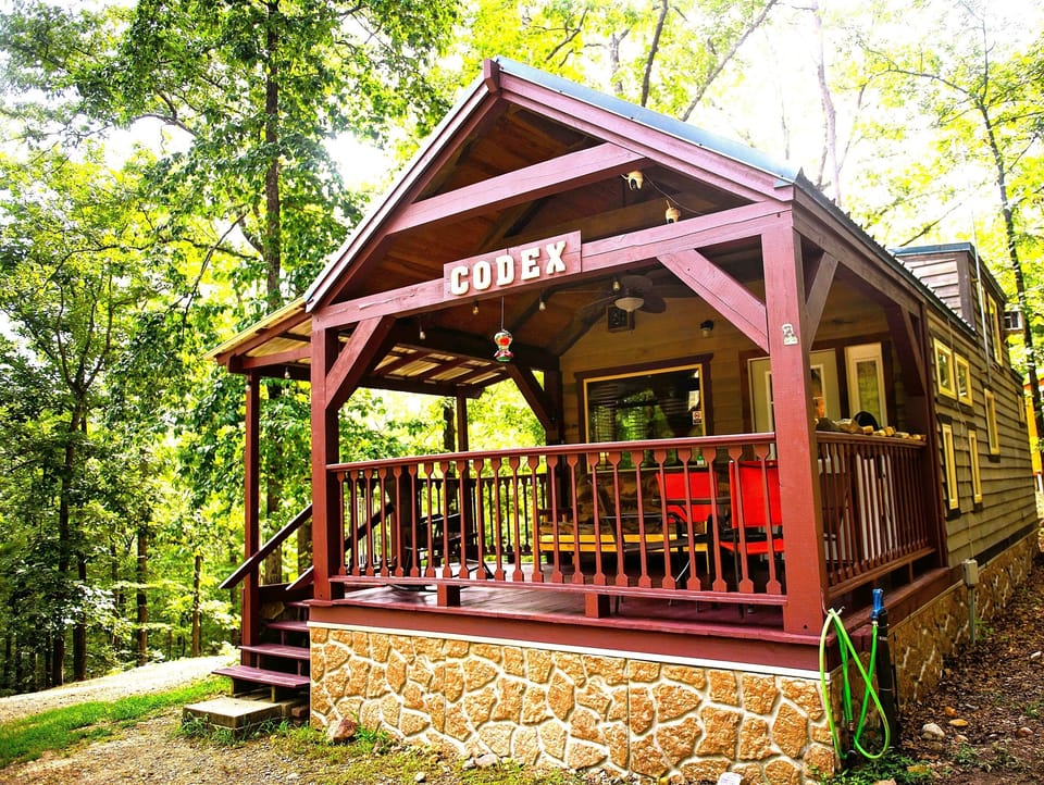 Cozy cabin retreat with forest views and a welcoming covered deck - private woodland escape ideal for peaceful getaways - rustic outdoor living perfect for relaxing in nature.