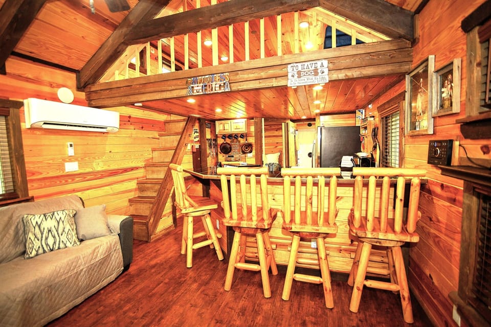 - Open cabin layout with wooden beams and bar seating   - Rustic charm ideal for forest-side relaxation   - Cozy atmosphere crafted for welcoming cabin stays