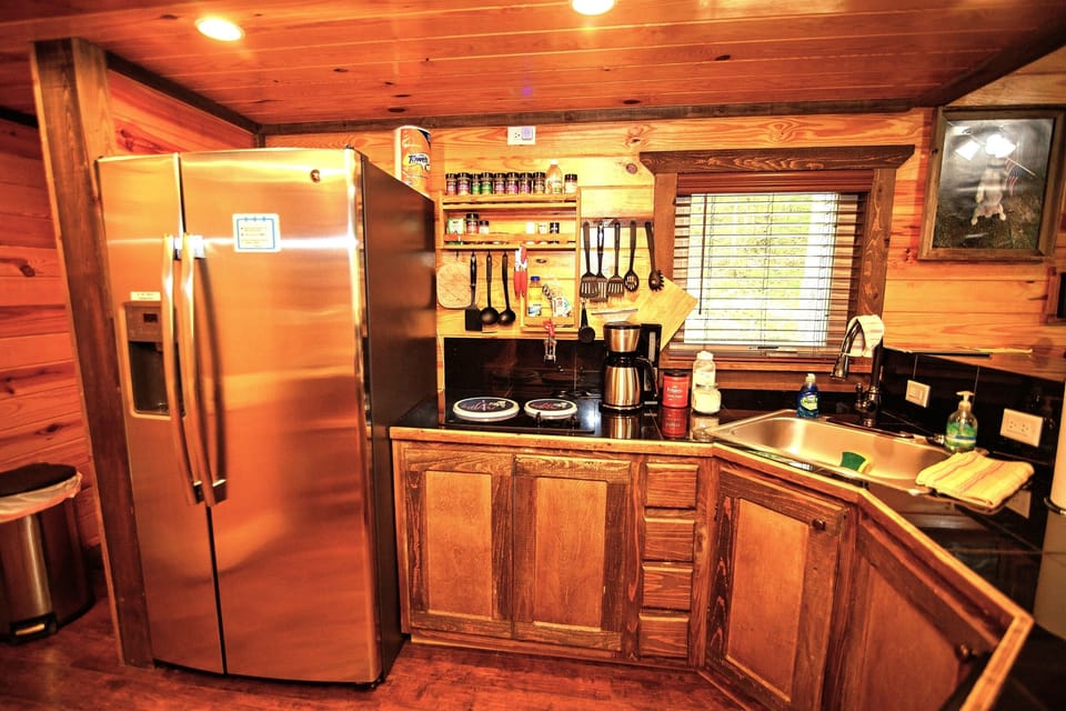- Fully equipped cabin kitchen with stainless appliances   - Rustic wood cabinetry ready for easy meal prep   - Forest getaway cooking space designed for comfort