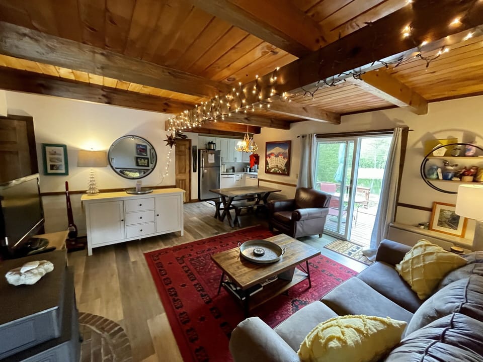 Dining area opens to living area, with rustic decor and fun art!