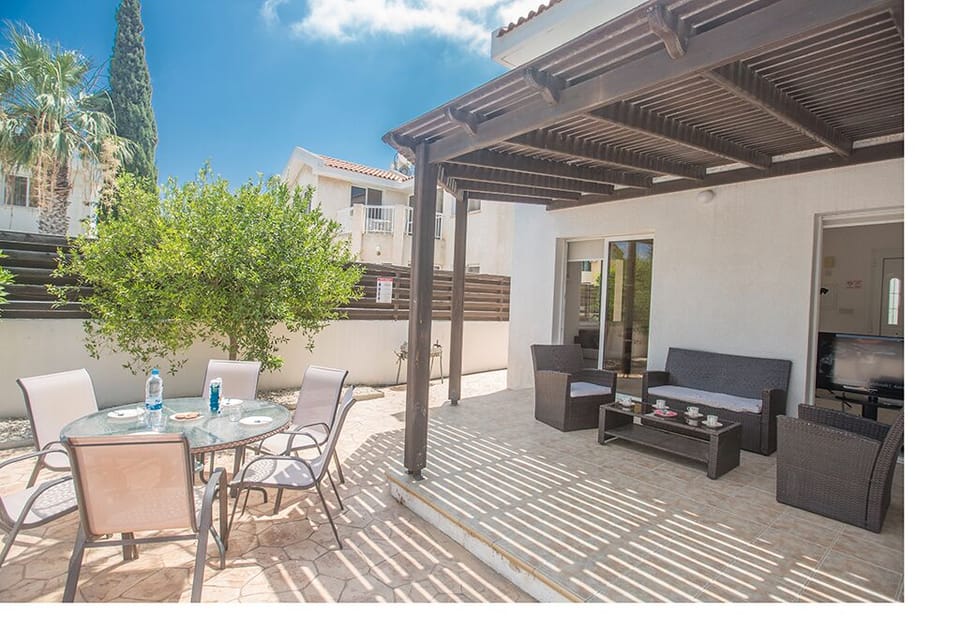 Outside dining area with seating for 6 people and shaded seating area