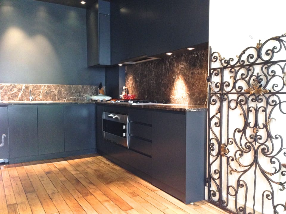 Kitchen with Italian marble, parquet, wrought iron gates.