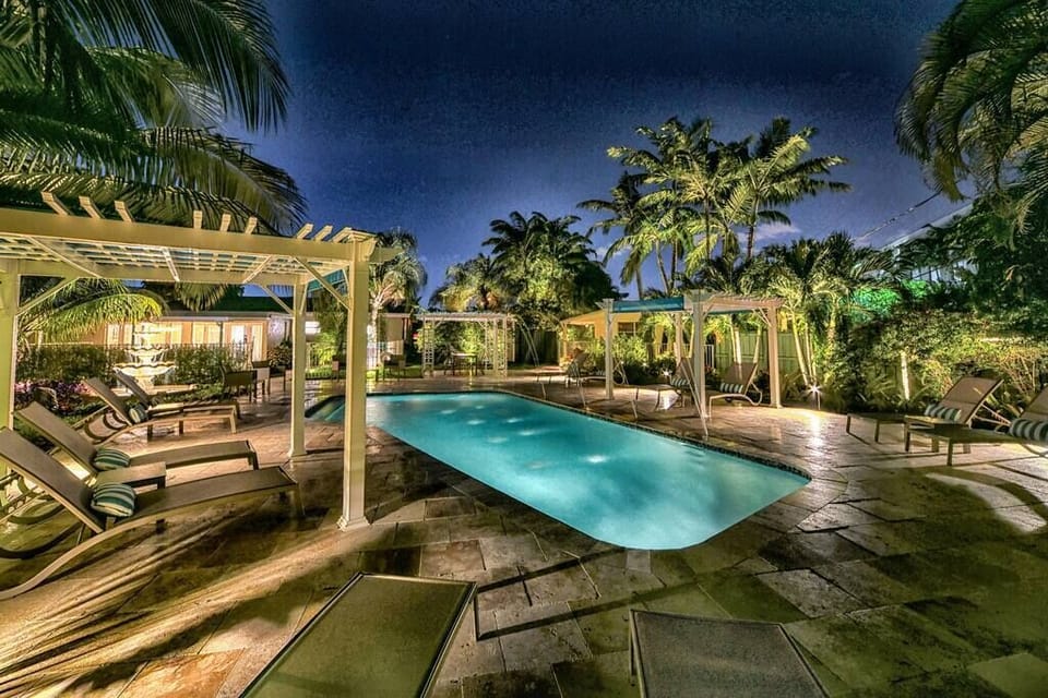Pool Deck and Tropical Palms lighted at night.