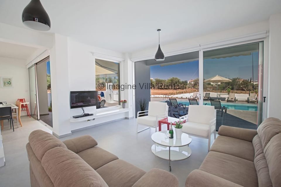 Living room with large patio doors leading to the garden and pool area