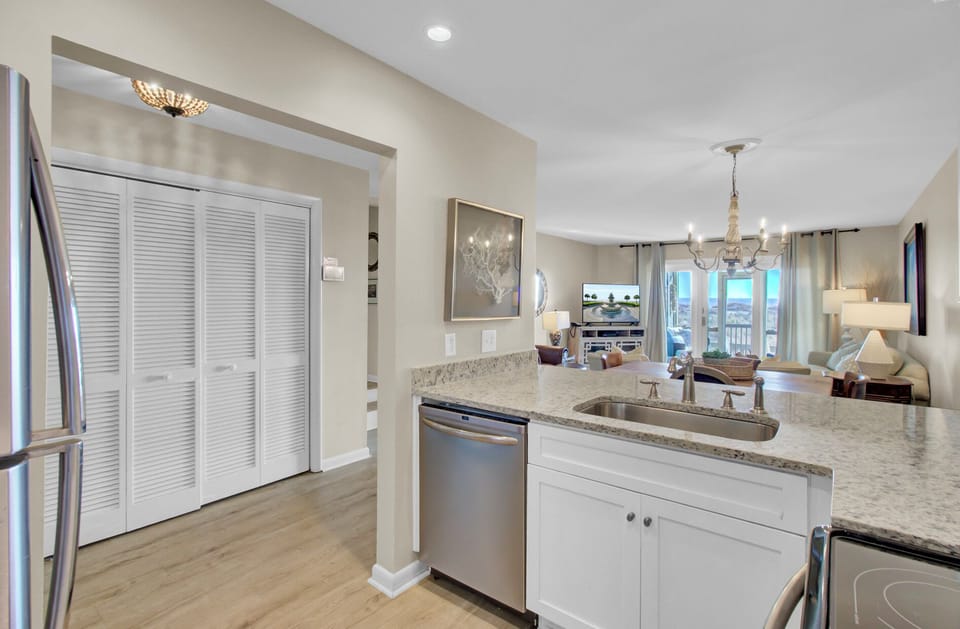 Your modern kitchen flows seamlessly into an elegant living space, featuring granite counters and stainless appliances for memorable meal preparation.