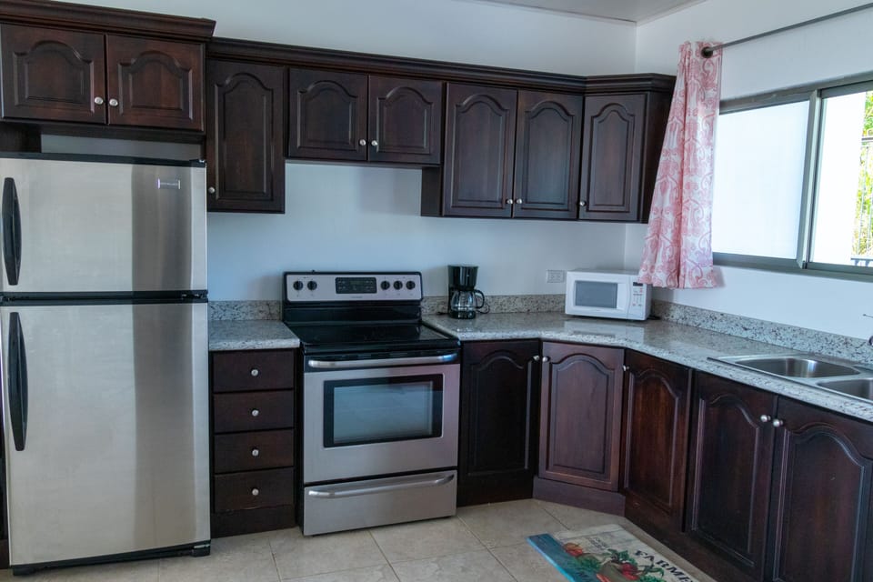 Kitchen with full refrigerator, etc.