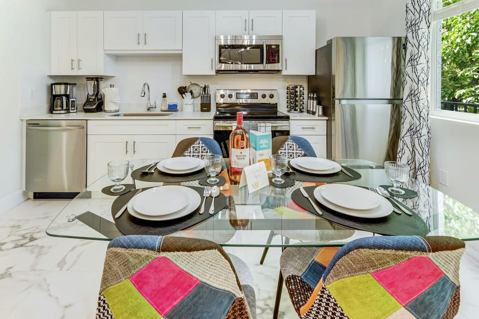 Glass top dining table comfortably sits four